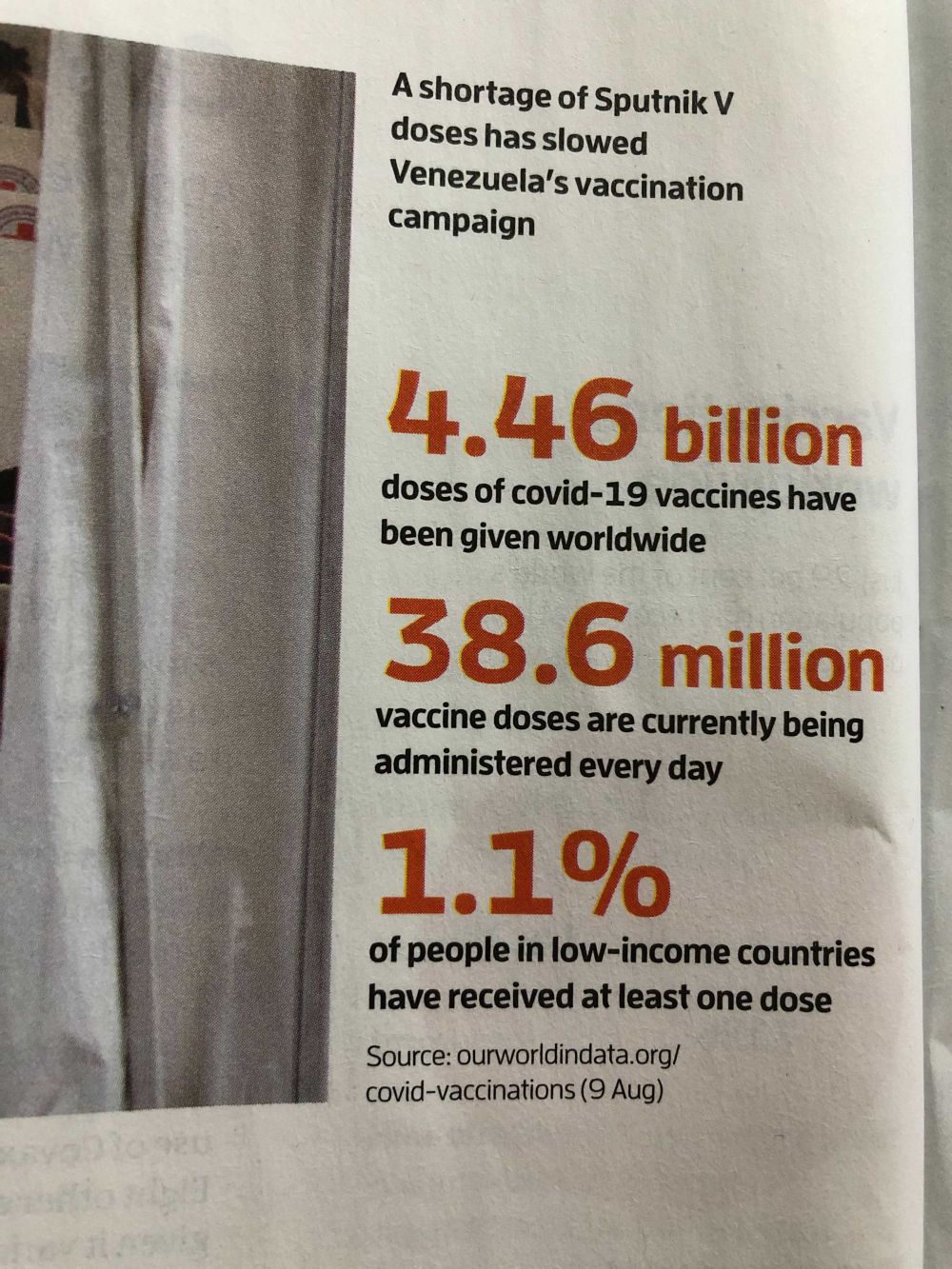 cropped image of a New Scientist magazine page showing three vaccination key numbers in large red print